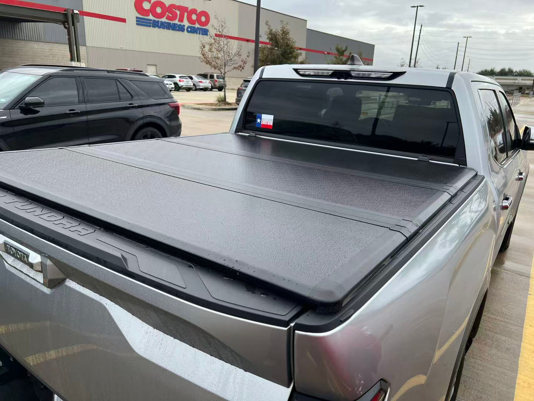Closed tonneau cover showing the panel seams and edges on a silver pickup truck