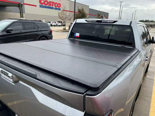 Closed tonneau cover showing the panel seams and edges on a silver pickup truck